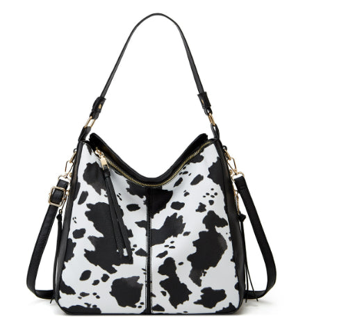 Black-and-white cowhide zipper bucket bag with adjustable shoulder straps