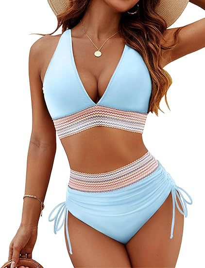 Woman wearing a light blue and white striped bikini with a straw hat on a white background