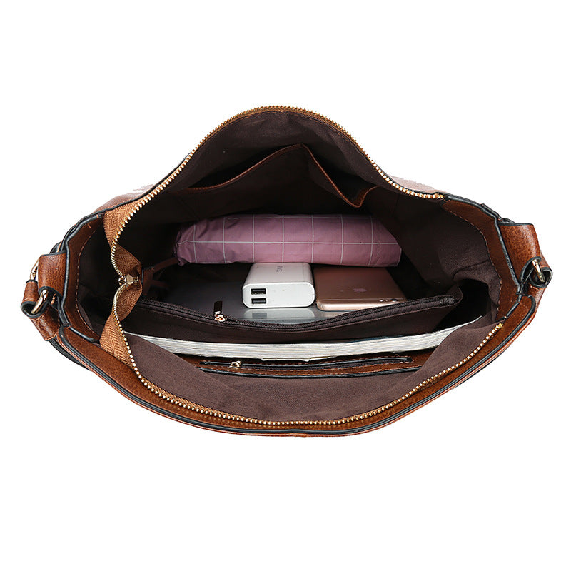 Brown zipper bucket bag with top zip, open interior and inner pocket detail
