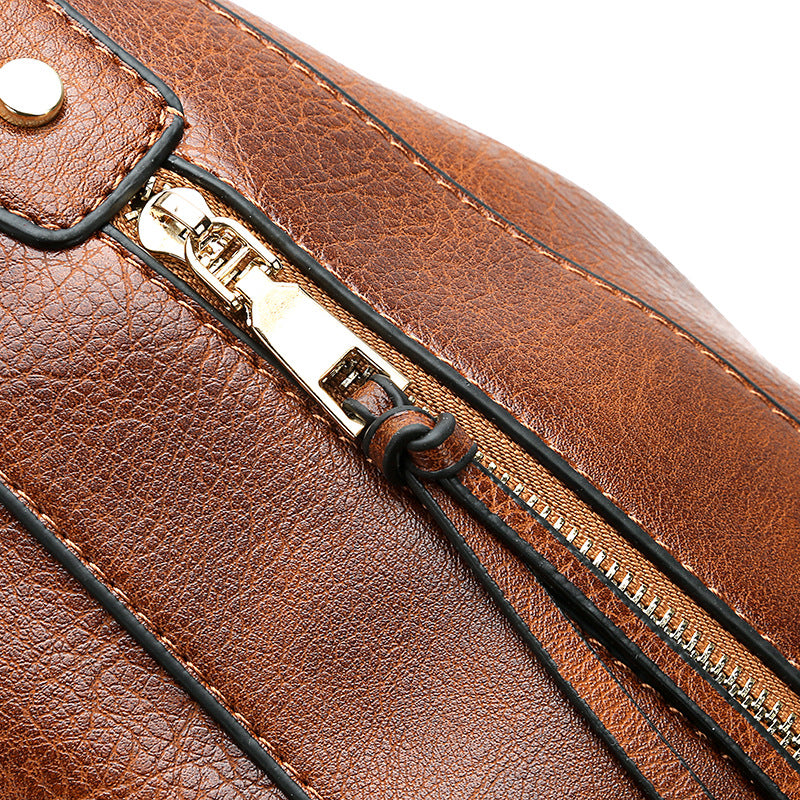 Close-up of hobo bucket bag zipper and hardware on brown leather-look