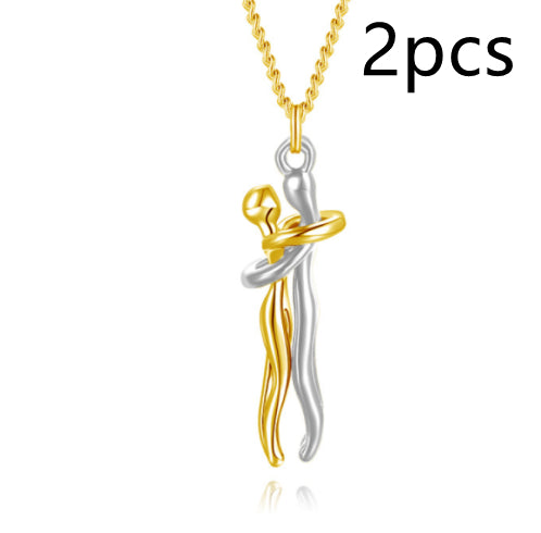 Gold tone love hug pendant necklace with two-tone hugging couple charm