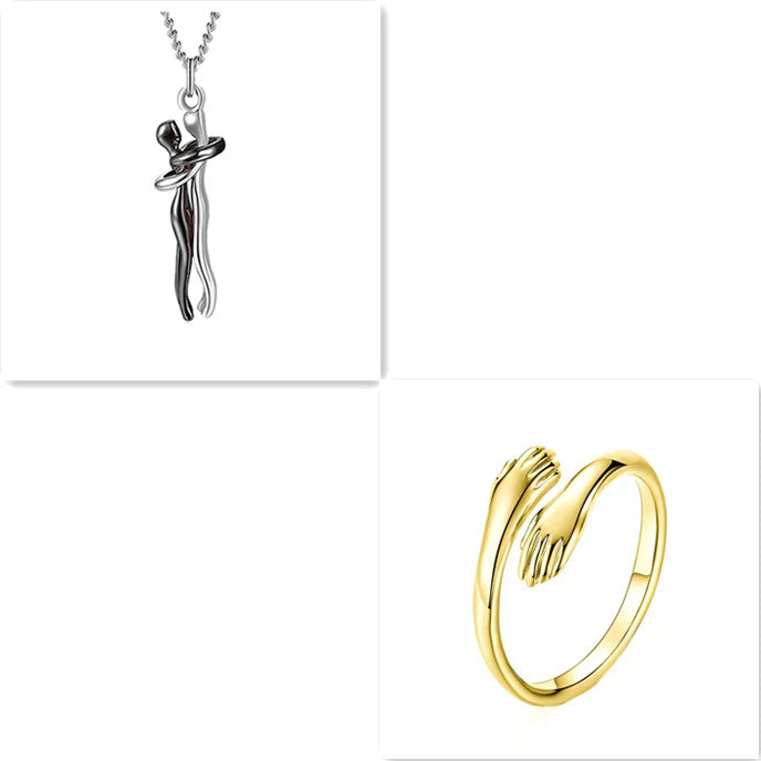 Silver hug pendant necklace and gold ring set with interlocking figure charm