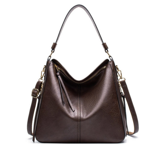 Dark brown zipper bucket bag with adjustable shoulder straps and top zip opening