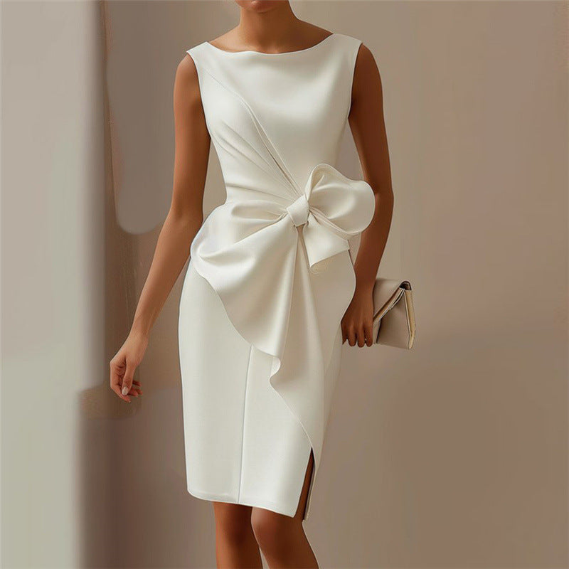 White dress with a large bow detail on a plain background
