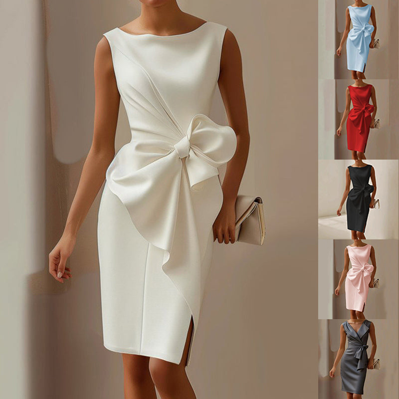 White dress with a large bow detail on a model against a neutral background.