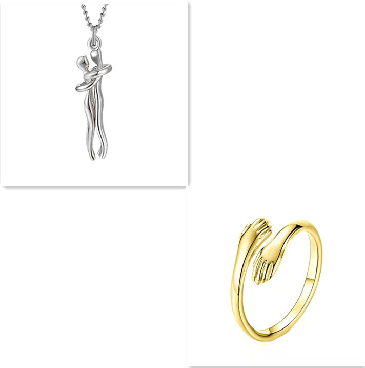 Silver-tone love hug pendant necklace with clasped figure, plus gold-tone ring