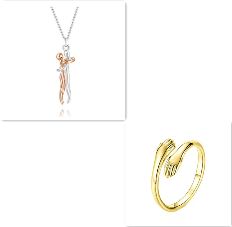 Rose gold love hug pendant necklace with clasped figures, silver chain